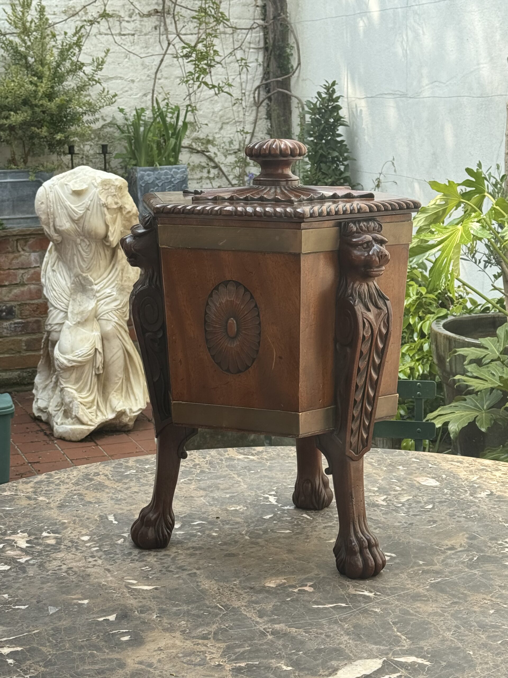 Hexagonal wine cooler, brass bound, monopodia, lion masks