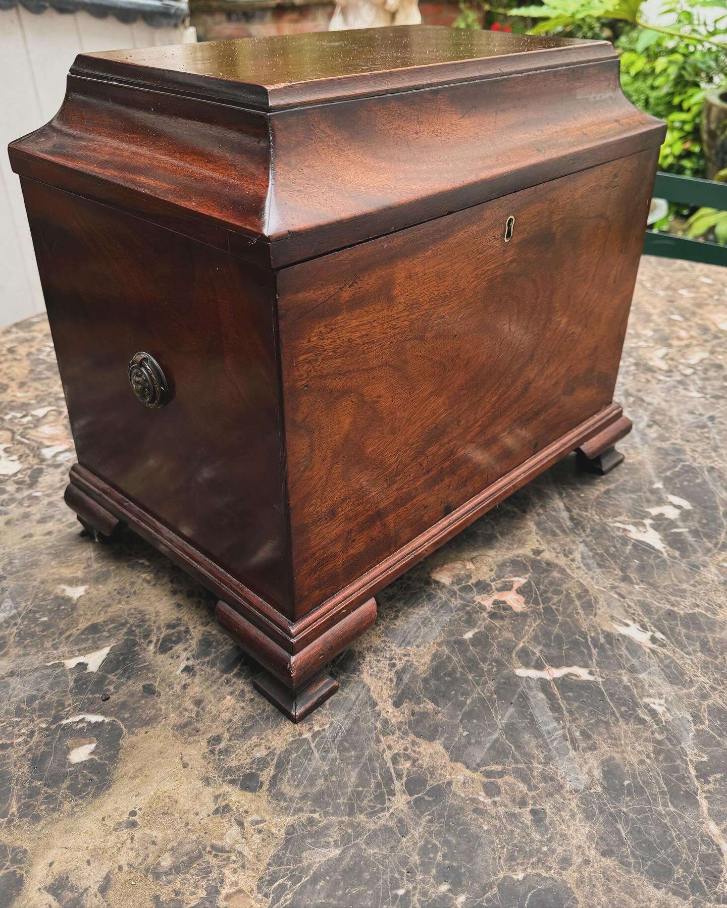 Mahogany cellarette, circa 1800 on ogee feet.
